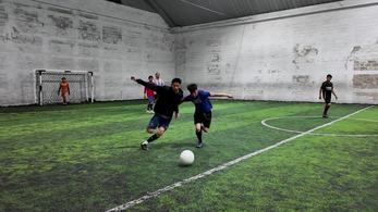 Teenagers playing soccer on field in guatemala
