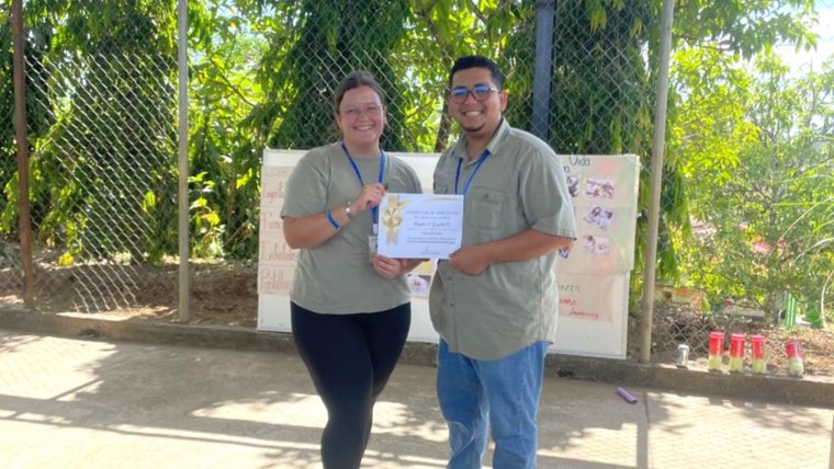 Sarah with her counterpart at the award ceremony for the community summer health and leadership camp.
