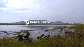 Picture of a lake with the peace corps logo