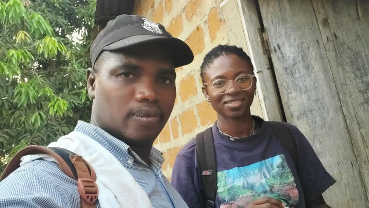 Blessing and community member prepare mosquito traps in Guinea.