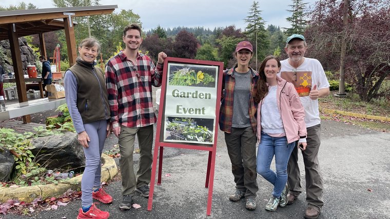 Five people at a community garden event.