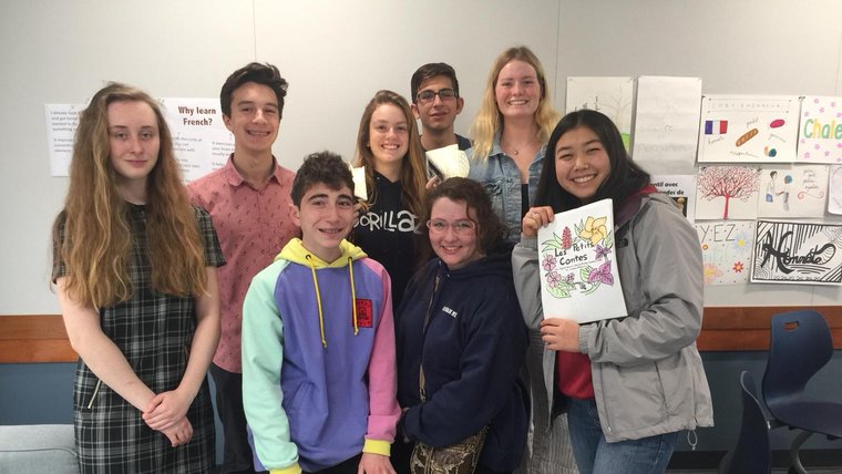 Students in California with books they wrote for children in Cameroon