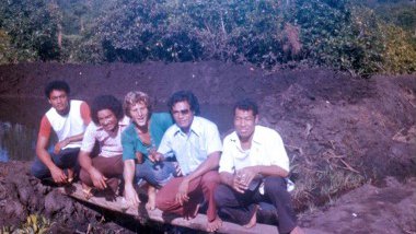 A Peace Corps Volunteer sitting with Samoan counterparts..