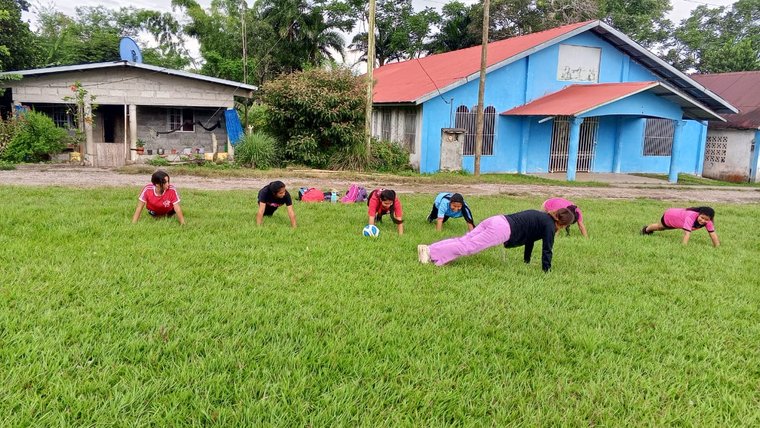 Panamanian students participate in exercises on the grass.