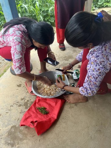 Women processing food in Nepal.