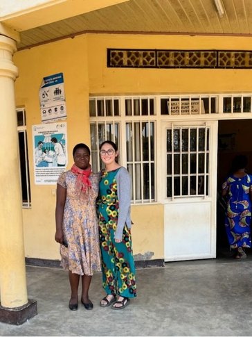 Maya and her counterpart, the nutritionist, in front of a health center in Rwanda.