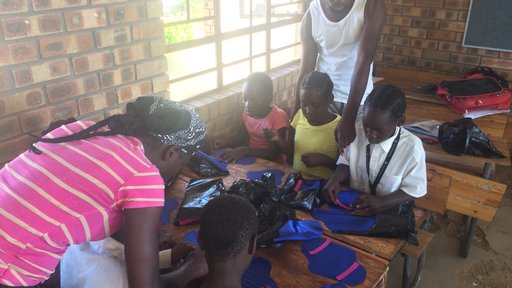 Child & youthcare workers help girls make RUMPs (reusable menstrual pads).