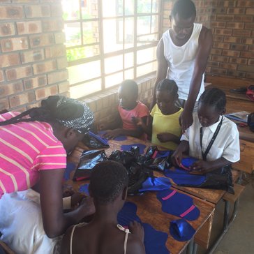 Child & youthcare workers help girls make RUMPs (reusable menstrual pads).