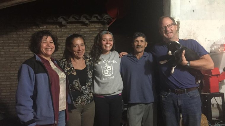 A PCV in Paraguay stand with both her biological parents and her host parents.