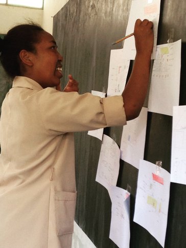 Girl drawing what she thinks is the ‘ideal’ latrine for girls to use when on their period at school