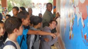 Painting a mural with another Peace Corps Volunteer