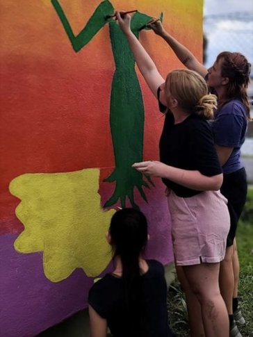 Making a mural with bottle caps.