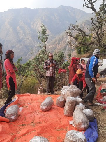 Community members preparing mushroom bags