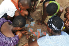First Place in Category 4: Photographic Technical Merit. Participants of Camp GLOW (Girls Leading Our World) work on solving an HIV puzzle. Photo by Peace Corps volunteer Jeanna Rolsing (Ghana, 2010-2012).