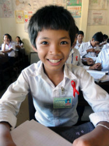 People’s Choice Winner. A student at a primary school in Cambodia shows his AIDS ribbon as he awaits a presentation on HIV/AIDS for World AIDS Day 2011. Photo by Peace Corps volunteer Matthew Dantism (Cambodia, 2011-2013).