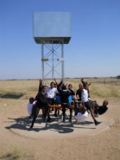 Children in South Africa pump water out of the merry-go-round style pump.