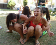 Female campers participate in a team building exercise.