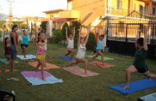 Female campers practice yoga.