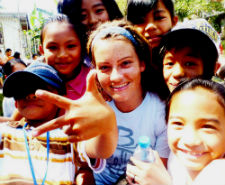 Peace Corps volunteer Kelsey Brannock with youth in her community.