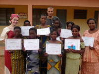  Returned Peace Corps volunteers Sandra Phillips and James Fischer pose with eight local girls and a camp counselor at the end of a Benin Camp GLOW held in 2008. Benin holds several regional camps every year.