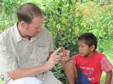  Peace Corps/Guyana volunteer Allen Neece teaches a young boy the alphabet in American Sign Language. Neece also served as a Peace Corps volunteer in Kenya.