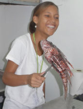 One of Bergmann’s students holds a lionfish during a culinary class in the Dominican Republic.