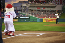 Peace Corps Director Aaron S. Williams throws the first pitch at Peace Corps night with the Washington Nationals.