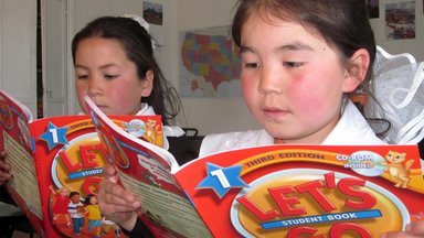 two 3rd-grade girls reading the same book