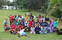 A group of volunteers and local residents smile