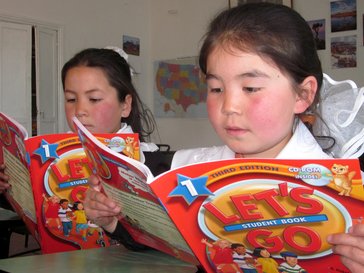 two 3rd-grade girls reading the same book