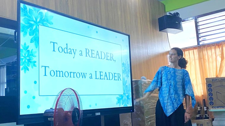 Lucy leads students at the library in a daily mantra.