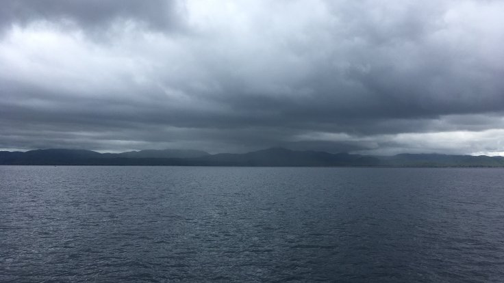 Storm clouds accumulate over a grey Lake Malawi