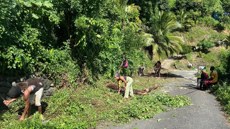 A community workday to improve road conditions make the community more accessible to taxis.