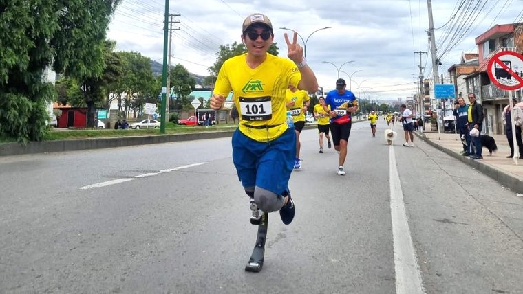 Kevin participates in many activities such as running (here in a half-marathon) and dancing in Colombia.