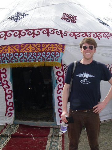 Tim stands in front of a traditional dwelling in Kazakhstan.