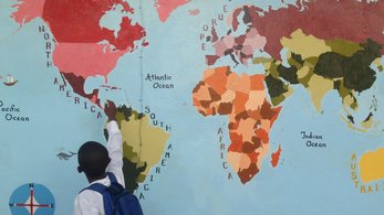 Student looks at map.