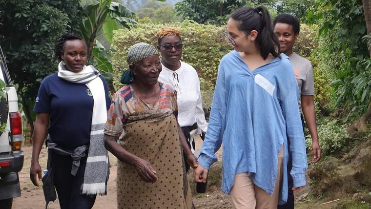 Maya with a community member during a local event in Rwanda.
