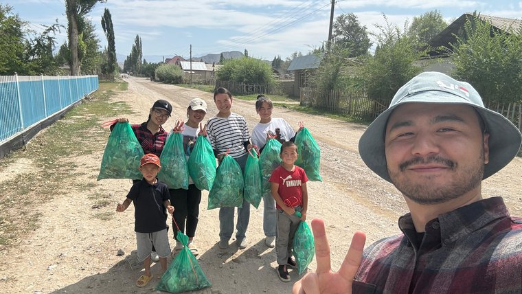 Jacob and his students clean up trash in their Kyrgyz village.