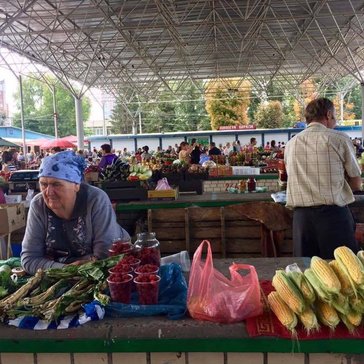 A woman selling her produce at the bazaar.