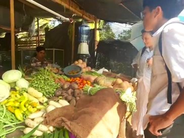 Two Volunteers buying vegetables