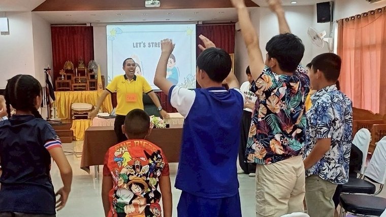 Brian leads a warm-up activity at a youth camp in Thailand.