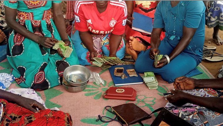 Members of a women's village savings and loan association supported by TCP Global, distributing loans.