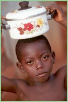 Photo of young girl with pot on head in Ghana.