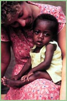 Photo of woman holding small child in Libya.