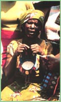 Photo of woman weaving basket in Cameroon.